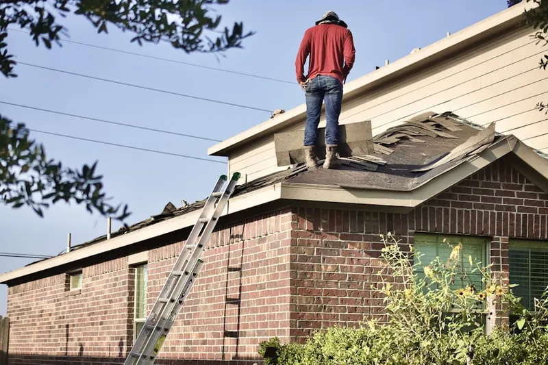 Professional roofer working on a residential roof in Woodchase